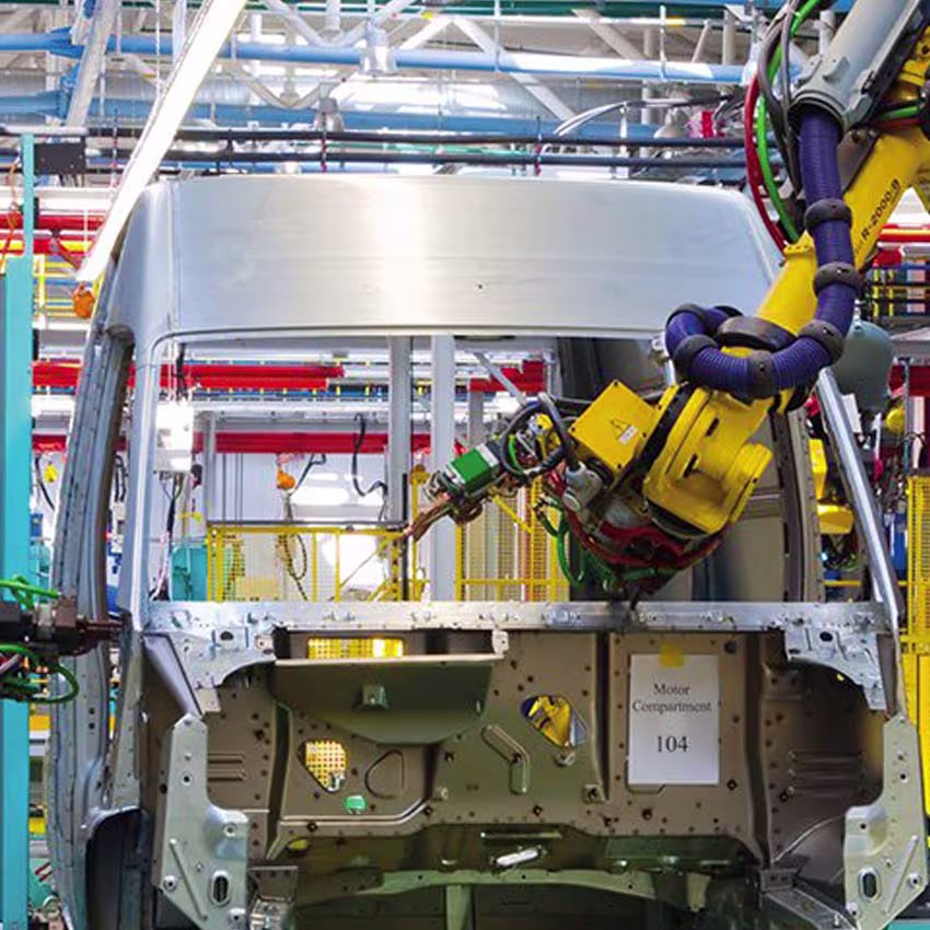 Industrial robot in an automotive production line working on a vehicle body