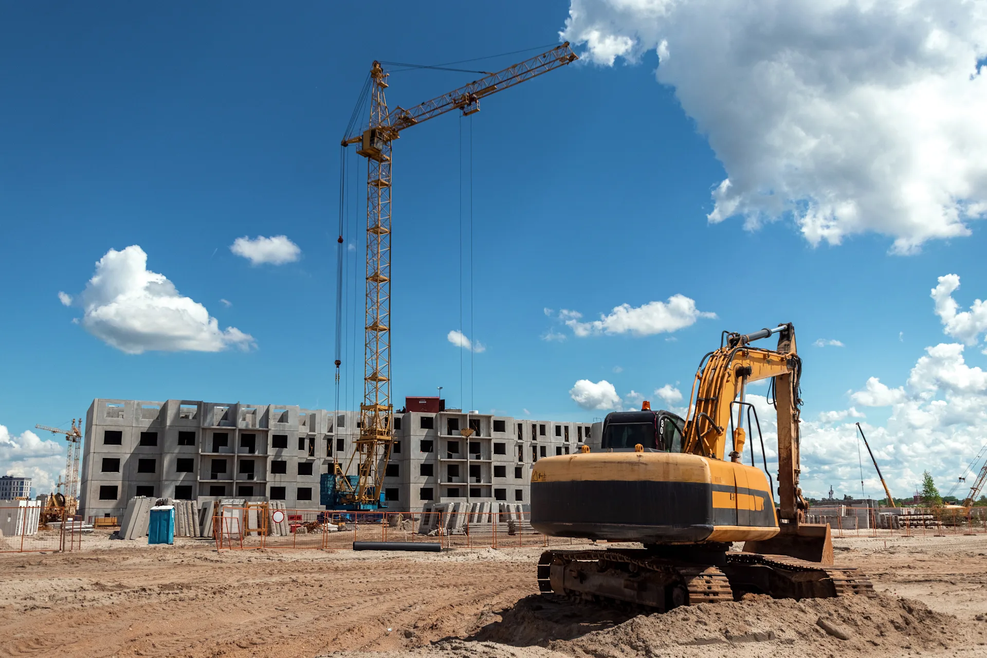 excavator-construction-site-against-background-tower-crae